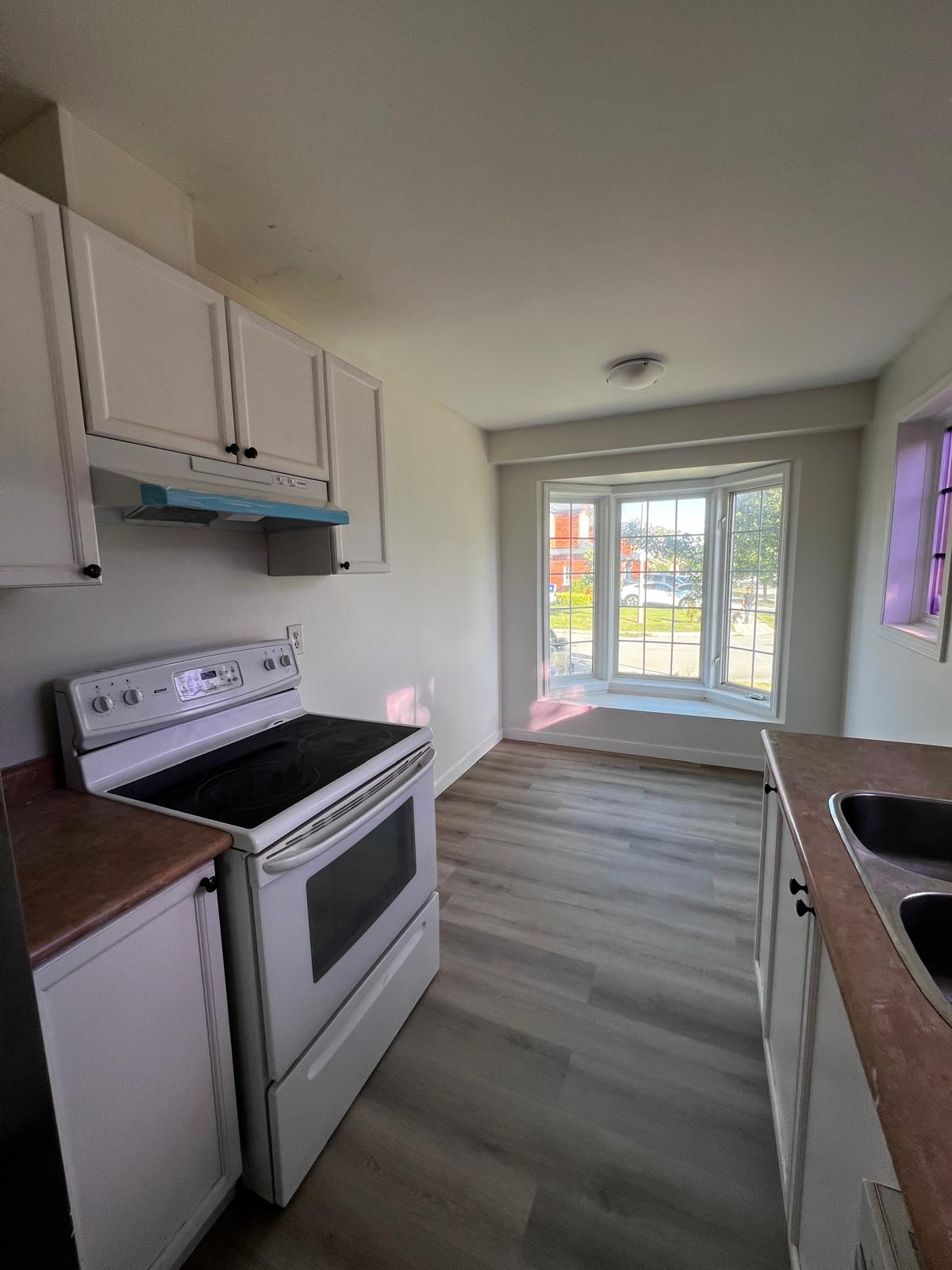 Renovated kitchen with new cabinetry and flooring